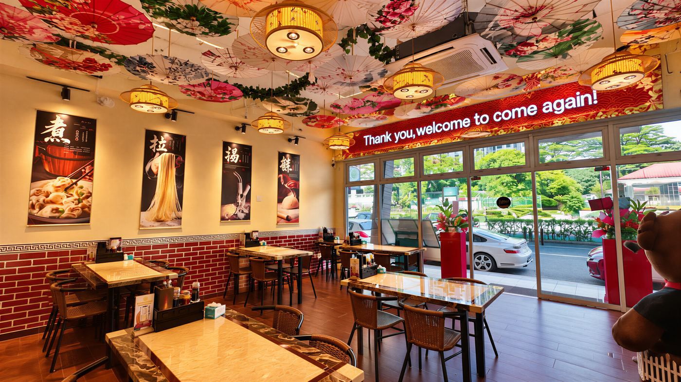 Inside Mi Empat Musim, Johor Bahru: paper parasols on the ceiling, lantern lights and marble tables